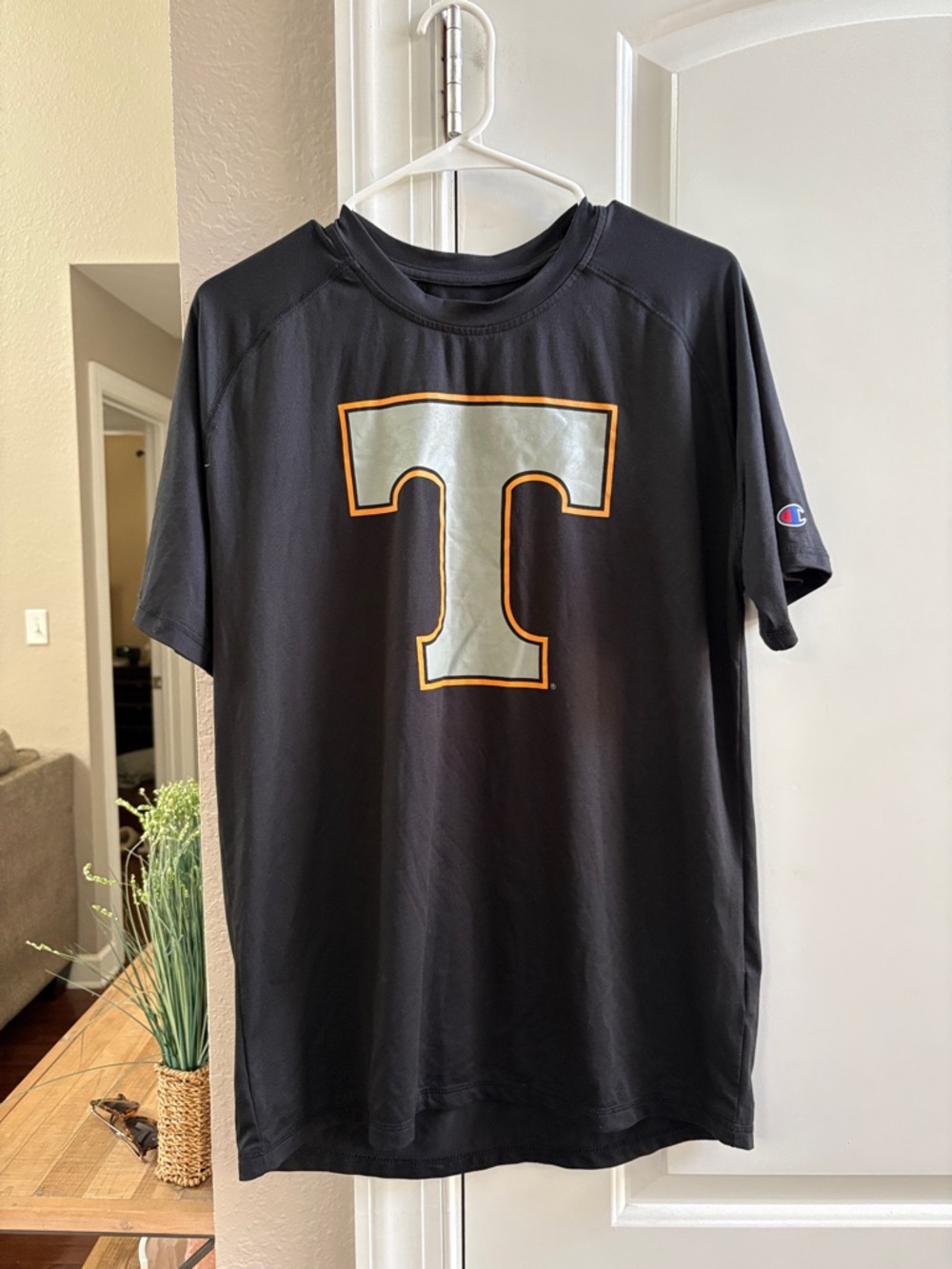 Champion Black Tee with Silver and Orange 'T' Graphic